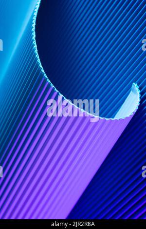 Abstract geometric background with violet and blue hues. Corrugated lines futuristic backdrop. Stock Photo