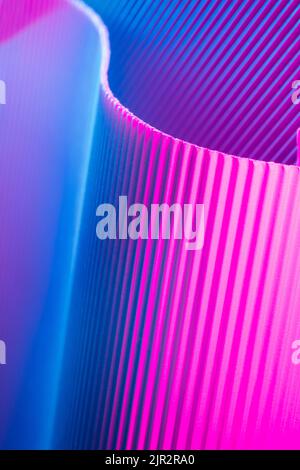 Abstract geometric background with pink and blue hues. Corrugated lines futuristic backdrop. Stock Photo