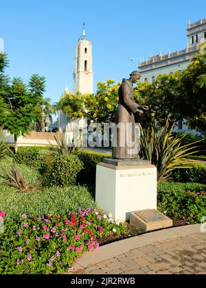 Bronze statue of San Diego de Alcala on the campus of the University of San Diego, in San Diego, California; Immaculata Parish tower in background. Stock Photo