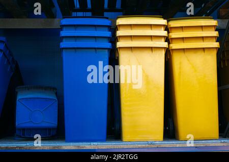Paper and plastic recycle bins, yellow and blue Stock Photo