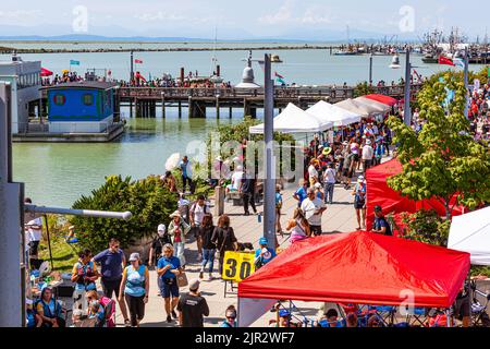 Crowded waterfront at the 2022 Steveston Dragon Boat Festival in British Columbia Canada Stock Photo