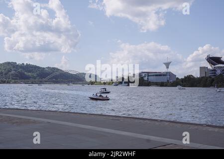 Nice day in the park to enjoy the river view. This is a park in Pittsburgh Pennsylvania USA. People on this park enjoy recreational activities. Stock Photo