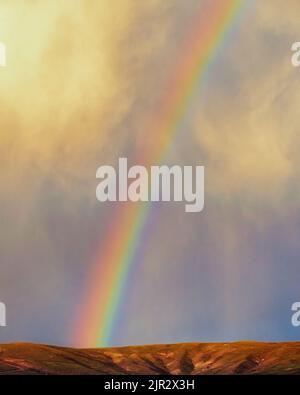 Rainbow over hills Stock Photo