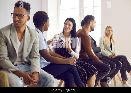 Multiethnic group of adult people communicating with each other in English class Stock Photo