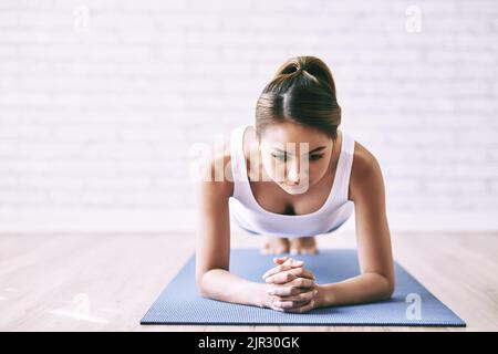 Asian young woman standing in plank position Stock Photo