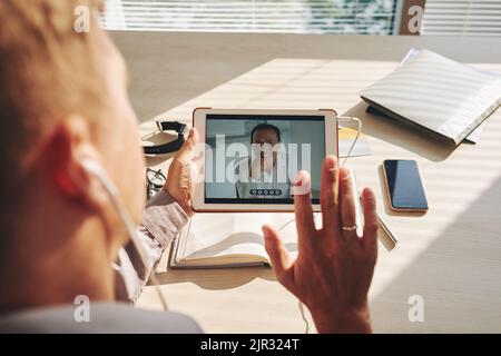 Businessman having a video conference on tablet with his colleague at office Stock Photo