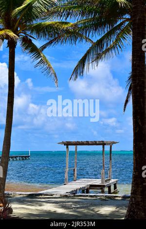 A view of a gazebo on a small pier, over the water, on a beach in San Pedro, Belize, Central America. Stock Photo