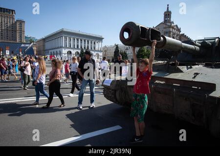 Kyiv, Ukraine. 21st Aug, 2022. A boy hangs on the cannon of a destroyed Russian tank displayed on the main street Khreshchatyk as part of the upcoming celebration of the Independence Day of Ukraine amid Russia's invasion of Ukraine in central Kyiv. (Photo by Oleksii Chumachenko/SOPA Images/Sipa USA) Credit: Sipa USA/Alamy Live News Stock Photo