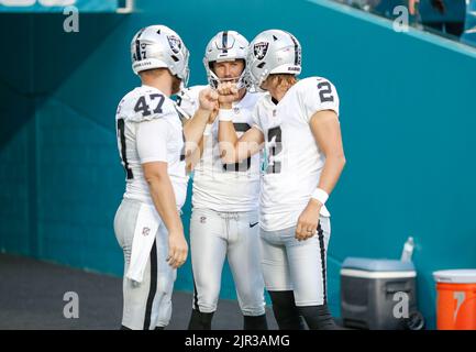 Miami. FL USA;  Las Vegas Raiders long snapper Trent Sieg (47),  punter AJ Cole (6) and place kicker Daniel Carlson (2) fist bump prior to an NFL pres Stock Photo