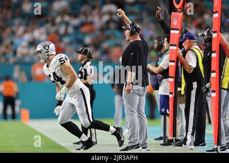 Miami. FL USA;  Las Vegas Raiders head coach Josh MdDaniels has defensive end Zach VanValkenburg (54) bring in a new play to the defense during an NFL Stock Photo