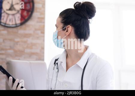 Confident female doctor posing in her office Stock Photo