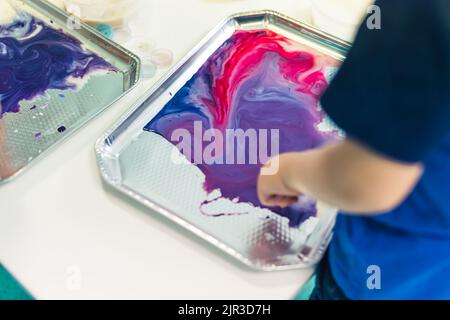 closeup view of a kid using paints in the kindergarten. High quality photo Stock Photo