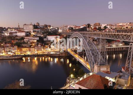 The iconic Dom Luis I Bridge in Porto, Portugal, carrying pedestrians, trams and road traffic over the Douro River as it flows through the city Stock Photo