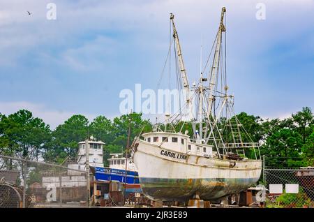 Shrimp boats sit in a shipyard while undergoing repairs, Aug. 19, 2022, in Bayou La Batre, Alabama. Stock Photo