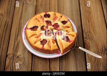 Plum and apple pie, cut, on wooden background horizontal Stock Photo