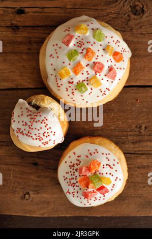 Kulich, Russian easter yeast sweet breads decorated with icing on wooden background topview vertical Stock Photo