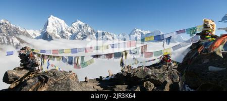 view from Gokyo Ri to Arakam Tse, Cholatse, Tabuche Peak, Thamserku and Kangtega with prayer flags - trek to Everest base camp - Nepal Stock Photo