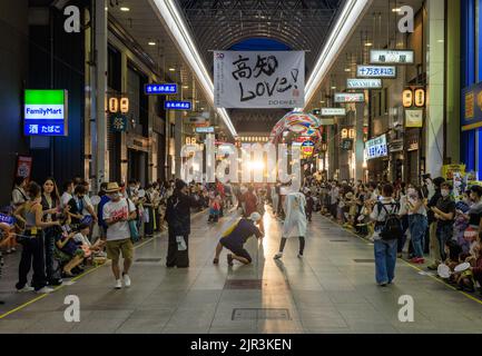 Kochi, Japan - August 10, 2022: Photographers take pictures of performers in covered shopping street during summer festival Stock Photo