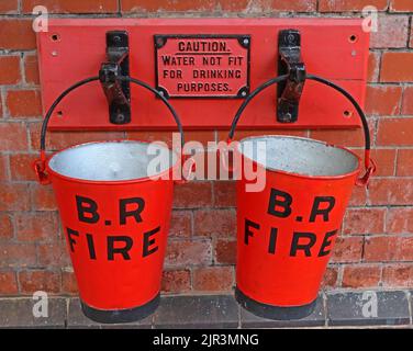 British rail Fire buckets. Warning sign, caution, Water not fit for drinking purposes, in iron, painted red Stock Photo