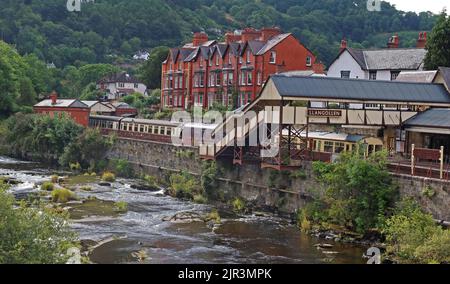 Llangollen preserved railway station, viewed across the fast flowing river Dee, Denbighshire, North Wales, UK, LL20 8SN Stock Photo