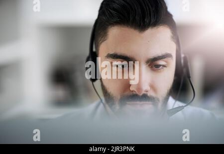 Good service is good business. a male agent working in a call centre. Stock Photo