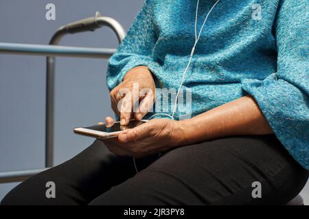 Elderly woman using mobile phone. Stock Photo