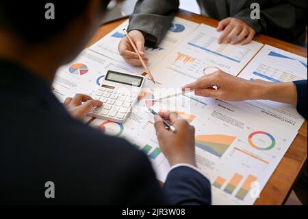 A professional and talented businesspeople or financial analysts analyzing financial data together. cropped and close-up image Stock Photo