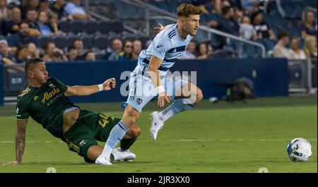 Kansas City, Kansas, USA. 21st Aug, 2022. Sporting KC midfielder Marinos Tzionis #27 (r) gains the offense, evading the tackle of Portland Timbers midfielder Marvin Loria #44 (l) during the second half of the game. (Credit Image: © Serena S.Y. Hsu/ZUMA Press Wire) Stock Photo