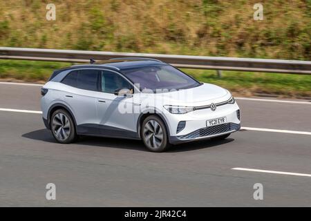 2021 White VW Volkswagen ID4 1st Edition Electricity 1 speed automatic EV car travelling on the M61 motorway, UK Stock Photo