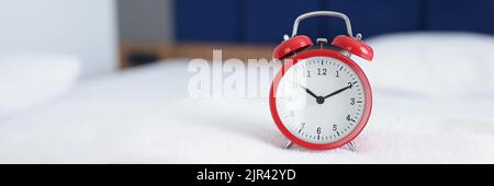 Alarm clock for ten in morning or evening on towels on beds Stock Photo