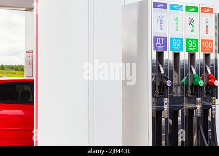 Close-up of fuel dispenser with colored handles nozzles to refuel. Refueling nozzles for diesel fuel, 95 and 100 petrol at the gas station. Fuel crisi Stock Photo