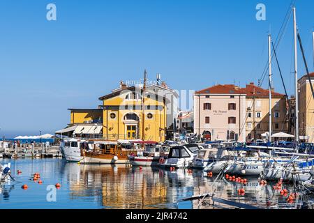 Piran, Slovenia - July 20, 2022: Port of Piran, marina with yachts and sailboats and resort town skyline, Adriatic Sea southwestern Slovenian coast. Stock Photo