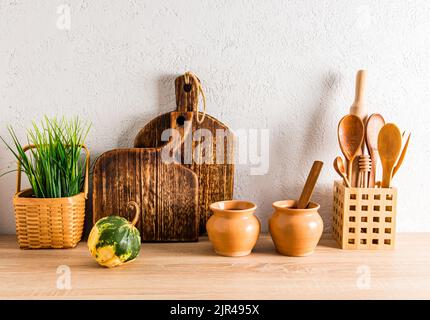 decor of the home kitchen of a country house. front view of a wooden countertop with kitchen utensils made of environmentally friendly materials Stock Photo