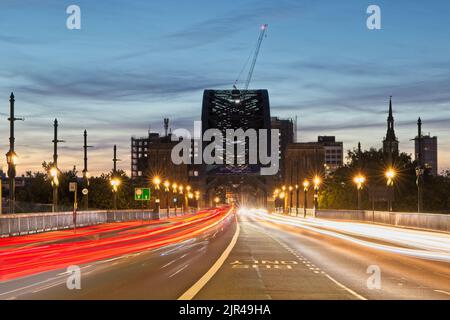 Light trails of traffic crossing the Tyne Bridge between Newcastle and Gateshead in Tyne and Wear, North East England. Stock Photo