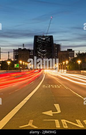 Light trails of traffic crossing the Tyne Bridge between Newcastle and Gateshead in Tyne and Wear, North East England. Stock Photo