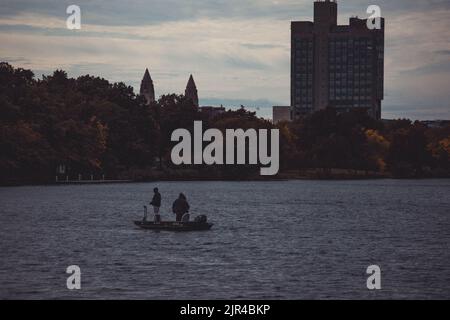 A scenic shot of two people on a boat on the Charles River in Boston, Massachusetts Stock Photo