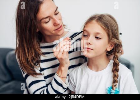 Mother and daughter do their own makeup Stock Photo - Alamy