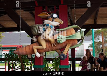 Powerpark, Finland - June 20, 2022: wooden rabbit flying on a carrot Stock Photo