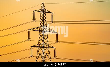 Close-Up of High Voltage Transmission Tower at Dusk Stock Photo