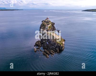 Aerial of the Rotten Island Lighthouse with Killybegs in background - County Donegal - Ireland. Stock Photo