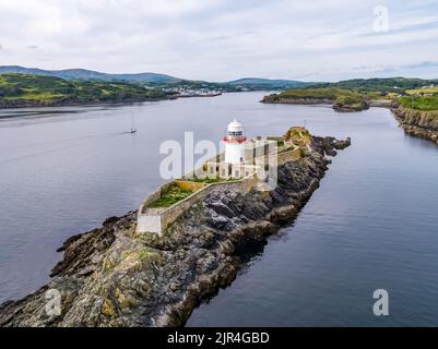 Aerial of the Rotten Island Lighthouse with Killybegs in background - County Donegal - Ireland. Stock Photo