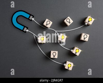 The magnet attracts and collects the best fresh ideas. Choosing the best ideas, innovation, creative thinking and searching for creativity. Stock Photo