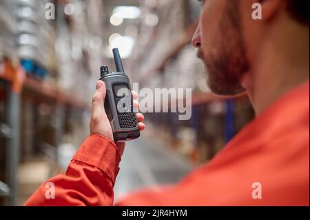 Storehouse worker with a walkie-talkie in the hand Stock Photo