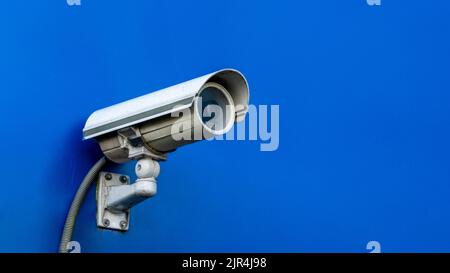 CCTV Security Camera on Blue Wall Stock Photo