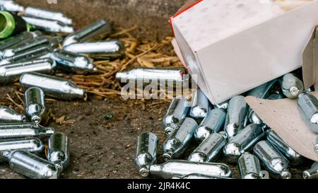Used and discarded Nitrous Oxide canisters Stock Photo