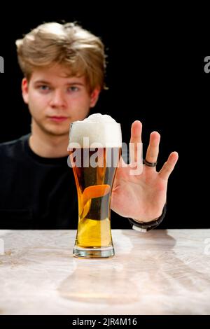 No alcohol. Young man refuses to beer. Young man stop drinking. alcohol addiction Stock Photo