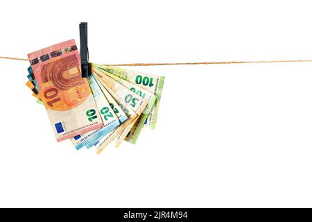 Euro banknotes hanging on a clothesline against white background. Money laundering concept Stock Photo