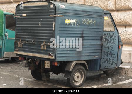 An old Piaggio Ape 50 in the cobbled back streets of Cefalu, Sicily, Italy,  outside some residential apartments Stock Photo - Alamy