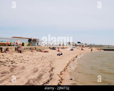 The popular small sandy Concord beach with tourists in the summer at Canvey Island, Thames Estuary, Essex, England, UK Stock Photo