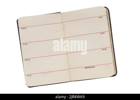 Old small week to page pocket diary open, isolated on white with path cut out Stock Photo